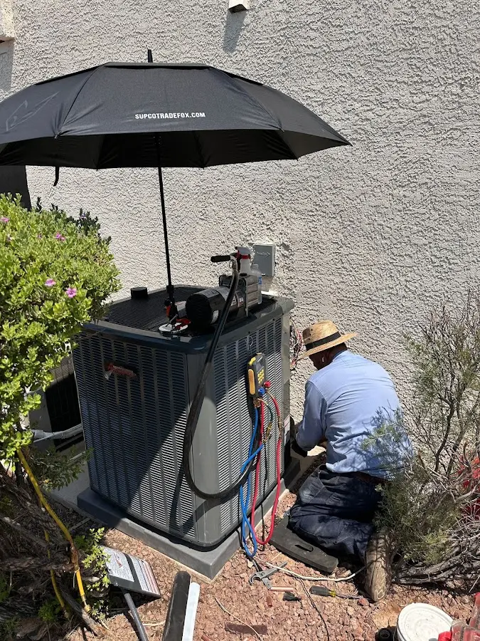 HVAC technician performing outdoor AC maintenance in Creedmoor