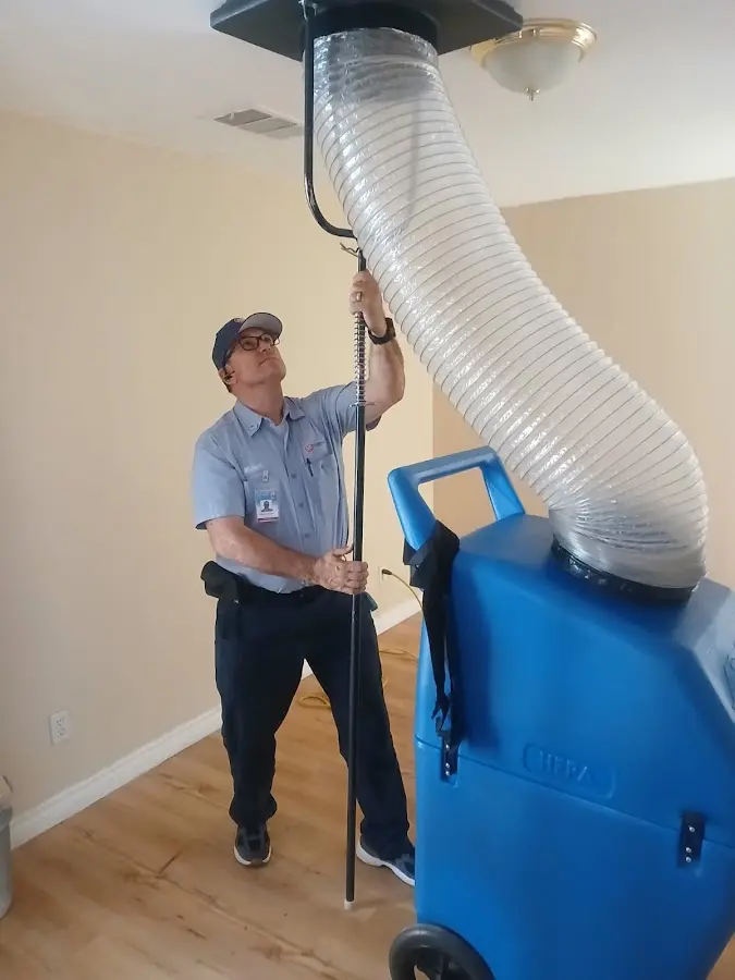 Furnace Tune-Up technician using HEPA equipment in Creedmoor