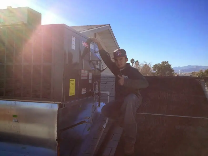 HVAC technician performing HVAC Inspection on a rooftop unit in Creedmoor